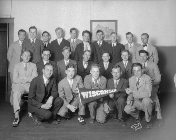 Group portrait of Wearever Aluminum salesmen, holding a Wisconsin pennnant.