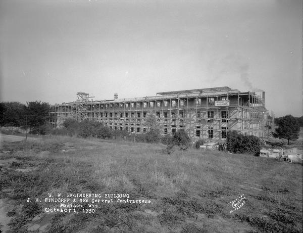 University of Wisconsin Mechanical Engineering Building, under construction, looking northeast, showing scaffolding around building and Findorff Builders sign, 1513 University Avenue.