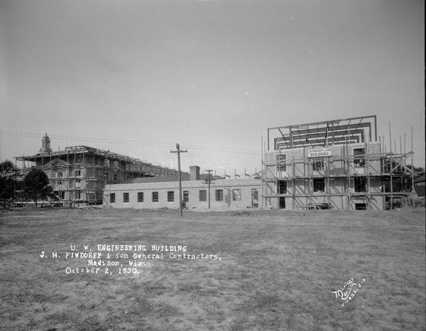 University of Wisconsin Mechanical Engineering Building, under construction, showing steel framework and scaffolding and Findorff Builders sign, 1513 University Avenue. View from the south.
