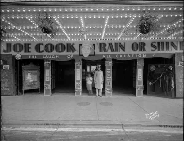 Capitol Theatre entrance advertising "Joe Cook Rain or Shine." The doorman is standing at the entrance with a child. 209 State Street.