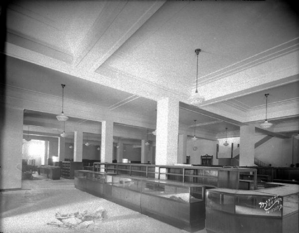 Interior of the first floor of Manchester's, 2 E. Mifflin Street, showing plaster work, and display cases.