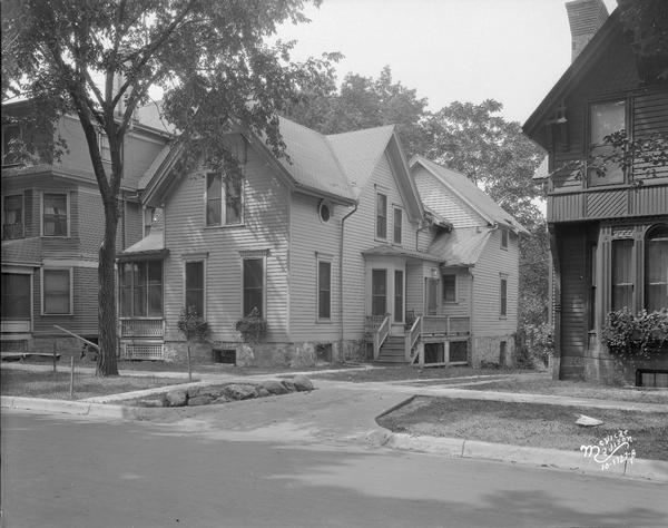 Edwin B. Fred residence at 610 N. Francis Street. There are houses next door on the left and right.