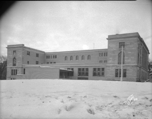 Exterior view of rear of finished Post Office and Courthouse, with snow on the ground.