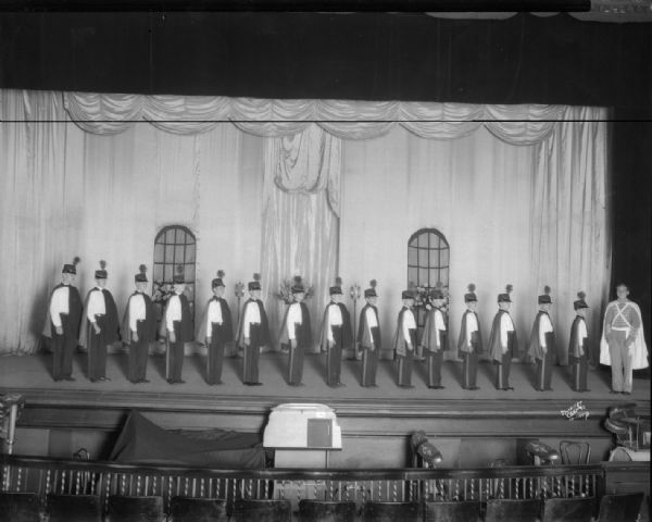 Elevated view of Floyd's Singing Cadets on stage. The cadets and leader are at the Orpheum theater.