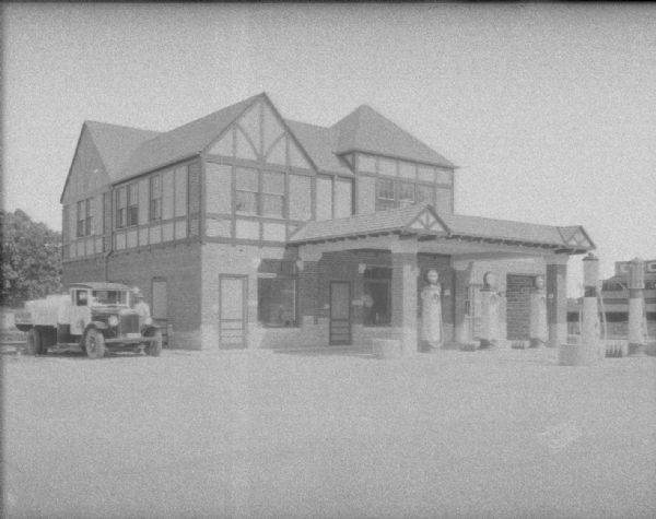 Cities Service service station from University Avenue towards the left side of the building at 2408 University Avenue. Text on back of print reads: "Blackhawk Oil & Fuel Co."