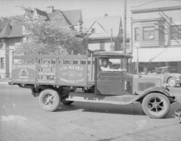 RKO movie advertisement on an Ed Klief Transfer Line truck. The U.W. Meat Market at 728 University Avenue is in the background.