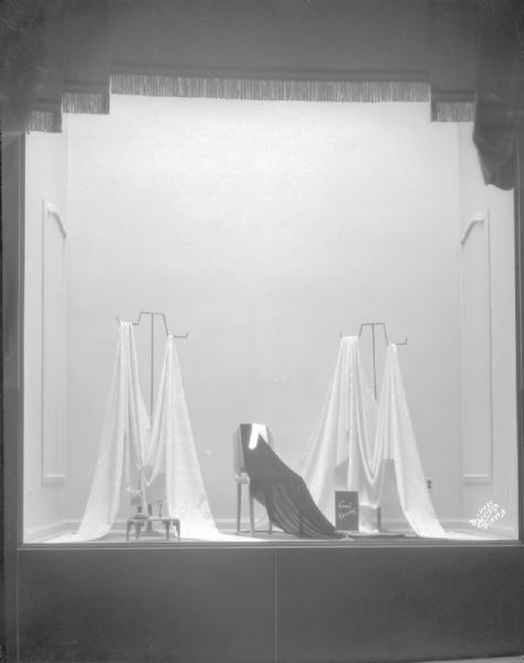 Manchester display window, showing three pieces of draped fabric.