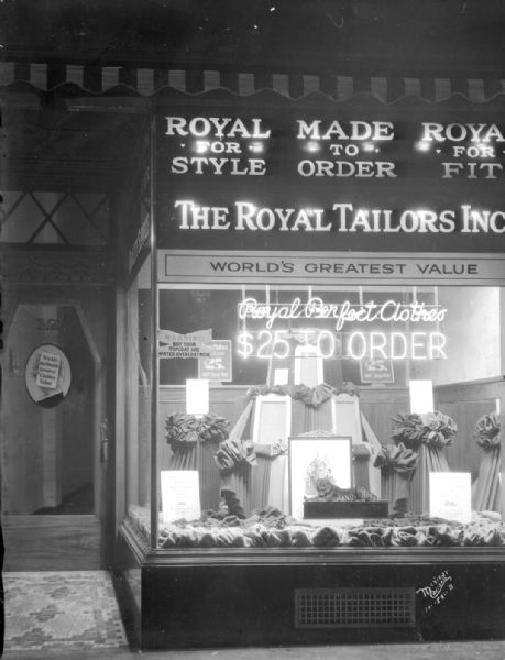 Window display at Royal Tailors, Inc., 12 E. Mifflin Street. The neon sign in the window reads: "Royal Perfect Clothes $25 To Order."