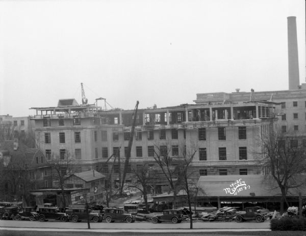 Elevated view of the Service Memorial Institutes fifth floor under construction, 470 N. Charter Street, University of Wisconsin from Charter Street. Showing nurse's home at 450 N. Charter Street.