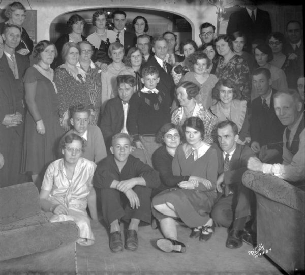 A large group portrait taken at a surprise party at Mrs. Peterson's (Aldro Wasley's sister), Sherman Park.