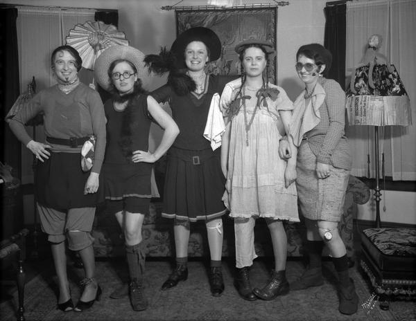 Group portrait of five American Automobile Association girls at a "hard times" party.