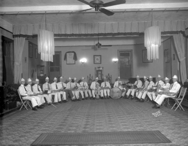 Group portrait of the I.O.O.F. (Independent Order of Odd Fellows) band in uniform, taken in Odd Fellows Hall.