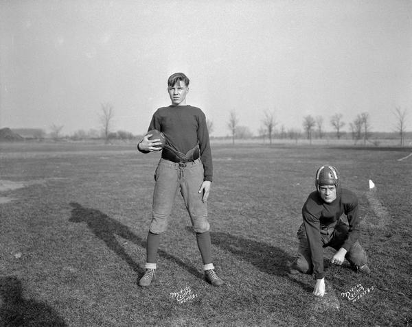 Two Middleton High School football players, George Beuman and Herman Thomas, posing outdoors in a field.