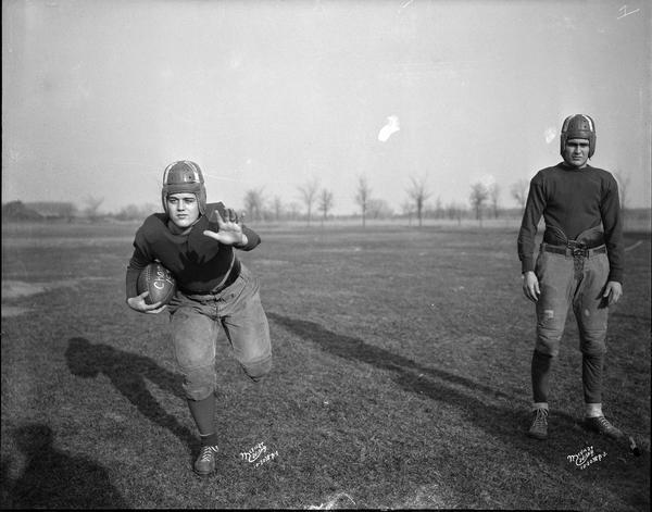 Outdoor portrait of two Middleton High School football players, F. Stricker and E. Baltes.