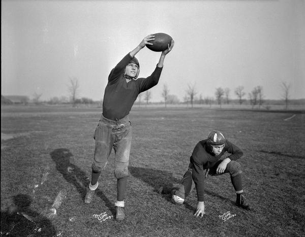 Outdoor portrait of two Middleton High School football players, Al Nordness and E. Schulze.