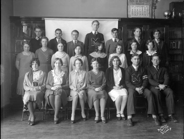 Group portrait of the Middleton High School annual staff taken in a classroom.