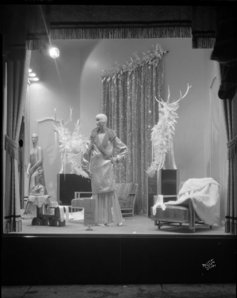 Holiday women's formal wear display window at Manchester's Department Store, showing two mannequins.