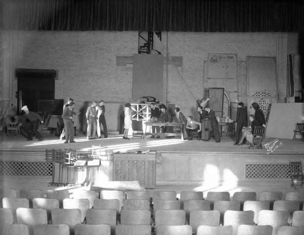 Action view of East High School dramatics class students rehearsing on stage.