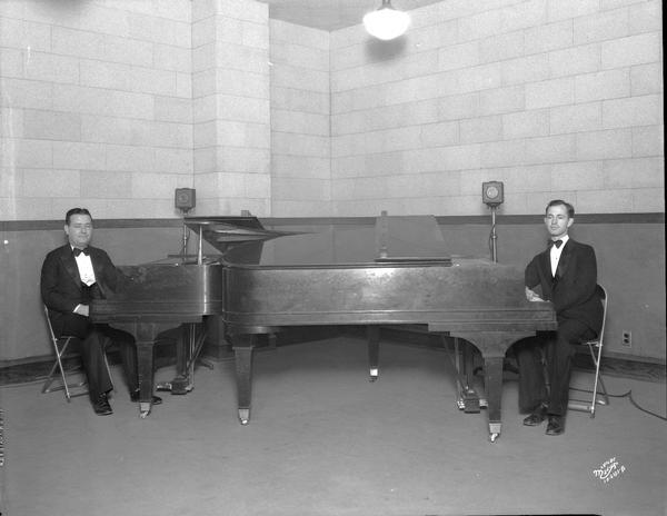 Two pianists are sitting at pianos at WIBA.