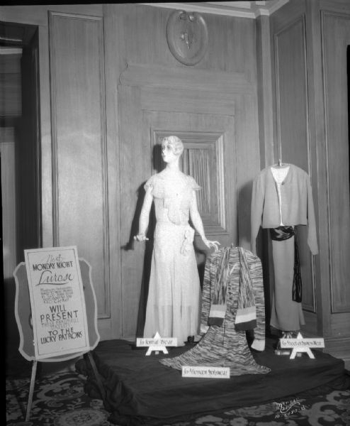 Display at Orpheum Theatre of three women's dresses from the Lurose Clothing Store, 205 State Street. Dress styles are formal wear, sports wear and business wear.