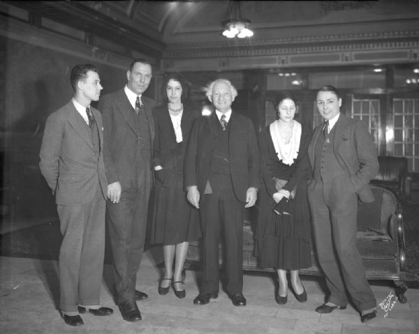 Karl Dane and George K. Arthur, Hollywood movie stars, standing in the lobby at the Park Hotel. Left to right: Harold S. Knudson, assistant manager of the Capitol Theatre, Karl Dane, Jean Powers, "Capital Times" staff, Solomon Levitan, State Treasurer, Blossom Bierbach, "Daily Cardinal," and George Arthur.