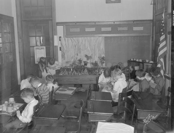 Dudgeon school children working at their desks in the classroom.