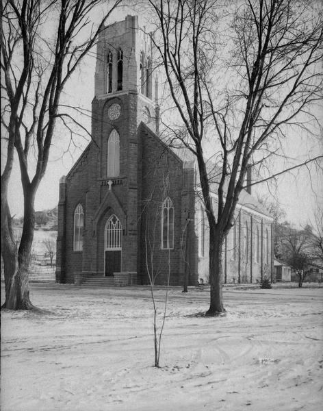 Exterior view of the St. Barnabas Catholic Church. Snow is on the ground.