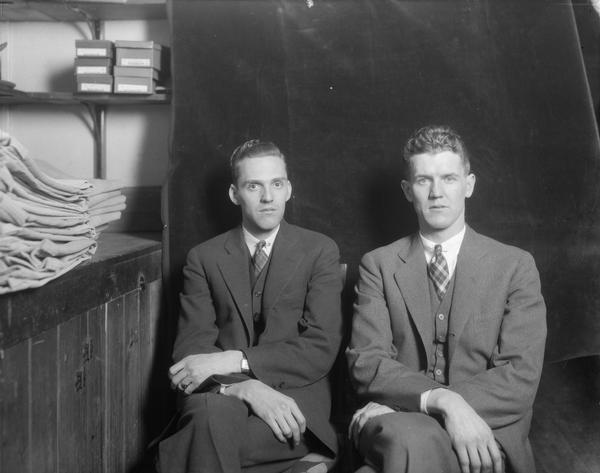 Informal portrait of Hal Hoak and Walter Dunn in their men's clothing store at 644 State Street.
