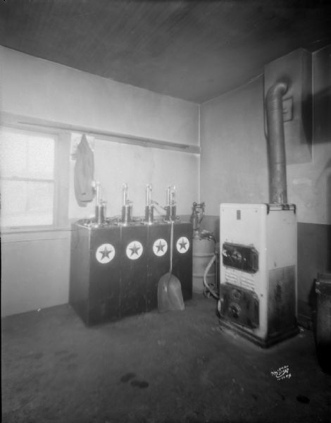 Fire-damaged furnace and pump room in Texaco service station.
