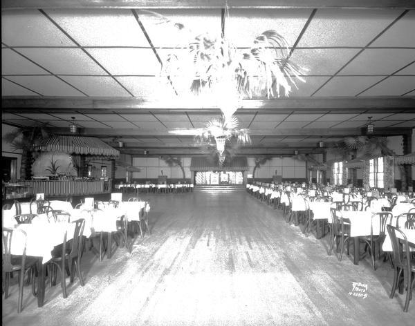 Interior view of the Chanticleer dance floor, showing tables, bar, and bandstand.