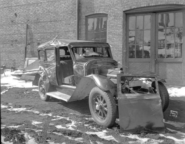 Wrecked Buick sedan at Hansen Auto Body Co., 113-123 S. Blair Street.