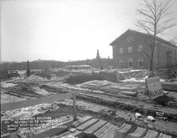 Constructing the foundation for the Agronomy wing (Moore Hall) to the Horticulture Building, 1575 Linden Drive, University of Wisconsin, Arthur Peabody, State Architect, and Immel Construction Co., Builders. Looking southwest from Linden Street, with Horticulture Greenhouse in the background.