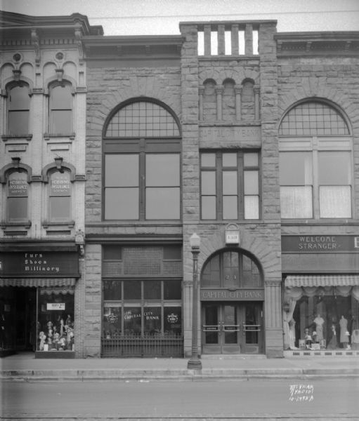 Capital City Bank Building, 21 E. Main Street, also showing Burdick & Murray Department Store, and Miller's Women's Apparel store.