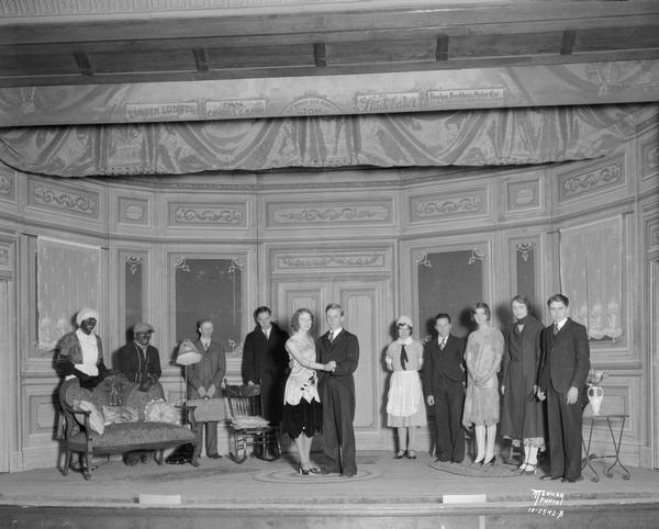 Portrait of Linden High School class play actresses and actors on stage.