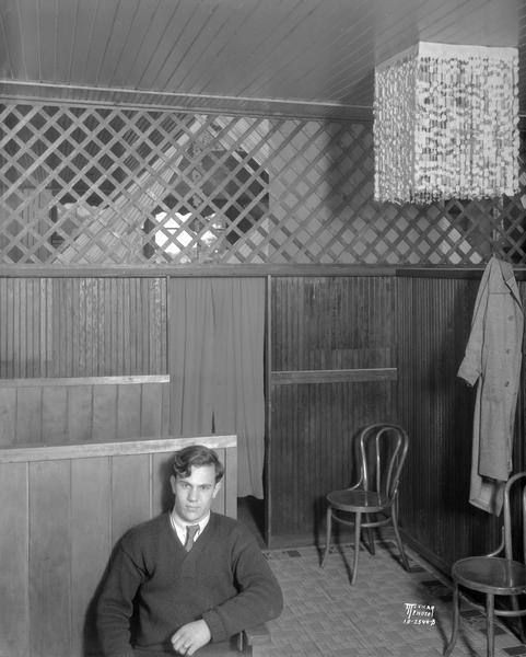 View of rear room of Joe's Place, with a man sitting in the foreground. 786 W. Washington Avenue, owned by Joseph Puccio, Greenbush.