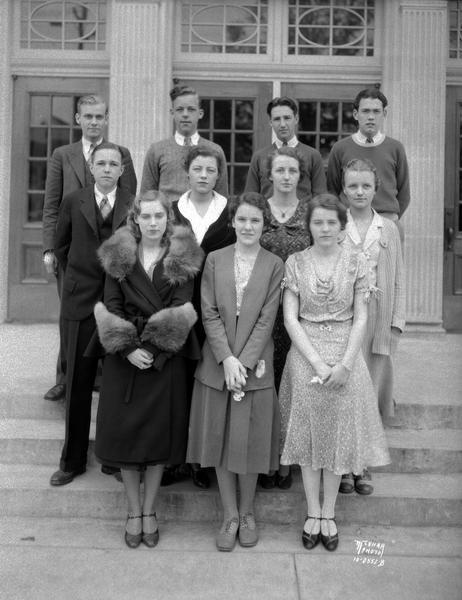 Portrait of West High School social committee, standing at Regent Street entrance.