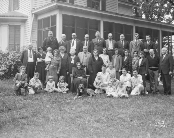 Multi-generational group portrait of the Samuel Miller family on the lawn outdoors at the home of C.L. Miller, Route 6.