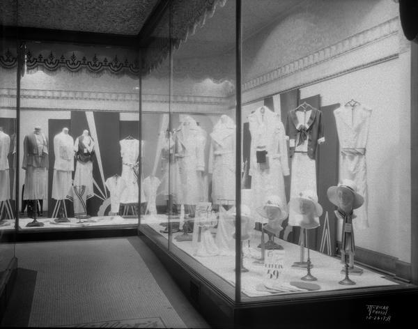 Two Miller's side display windows featuring women's clothing and hats, 544 State Street.