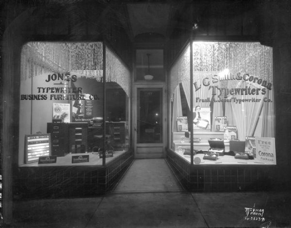 Frank A. Jones typewriter company. Showing both display windows for L C Smith & Corona typewriters and business furniture. 514 State Street.