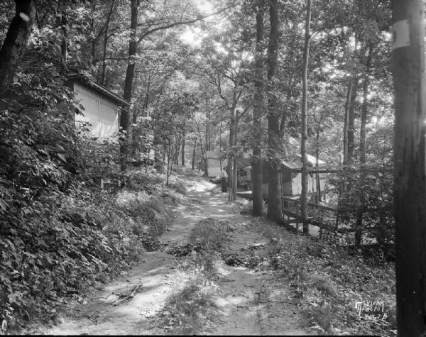 Path, "main street," through the woods at the University of Wisconsin Tent Colony. Also known as Camp Gallistella on the south shore of Lake Mendota, west of second point.
