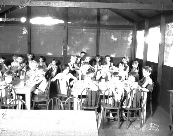 Children eating at Kiddie Camp.