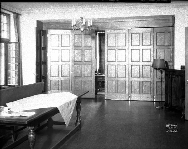 Interior of St. Francis house showing folding wooden door panels.