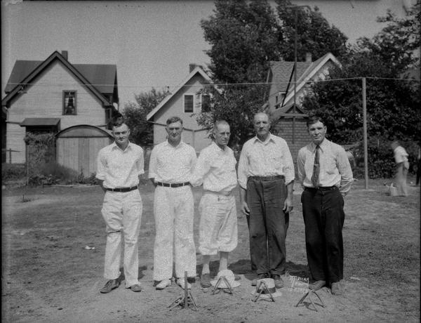 Five members of the Madison Horseshoe team, at the horseshoe pit, in a neighborhood setting. Ed Tierney, Seymour J. Johnson, Julian Johnson, L. Messerschmidt, Fred Qualley (not necessarily in the order of the picture).