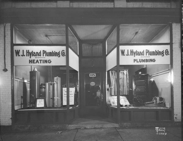W.J. Hyland Plumbing Co., 115 E. Doty Street, display windows featuring water softeners and steam boiler.