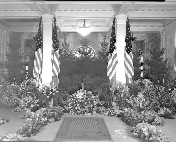 Floral display for the funeral of Belle Case La Follette, the wife of Robert M. La Follette, Sr., in the State Historical Society of Wisconsin Building.
