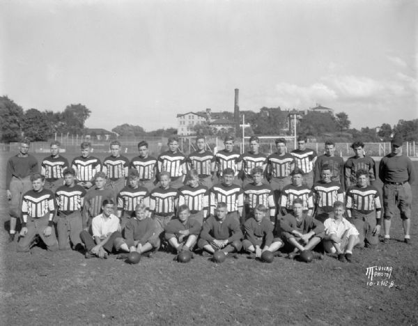 Outdoor group portrait of the Wisconsin High School football squad in uniforms.