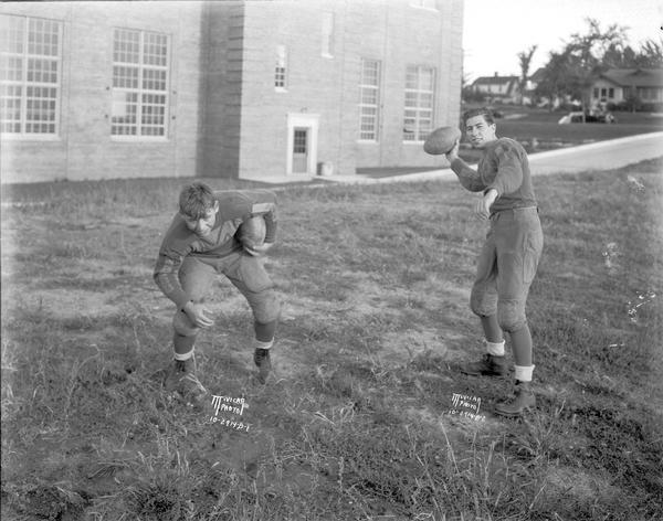 West High School, with two football players posing outdoors.