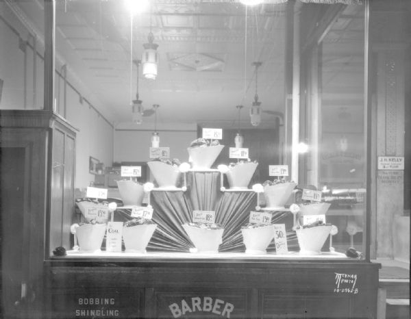 Window display of Conklin & Sons Coal Co. showing scuttles of different kinds of coal, 24 E. Mifflin Street.