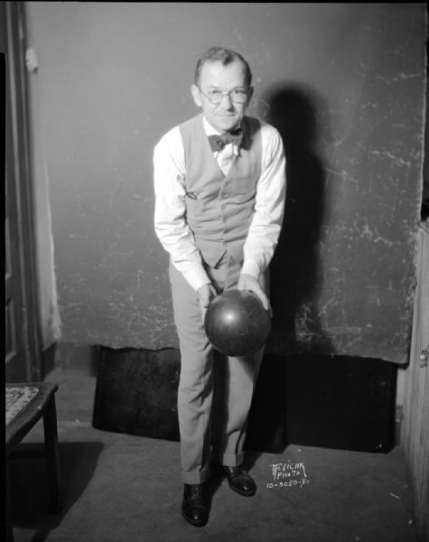 Frank Ross posing in bowling stance after bowling perfect game in the Cosmos league at the Plaza Alleys.