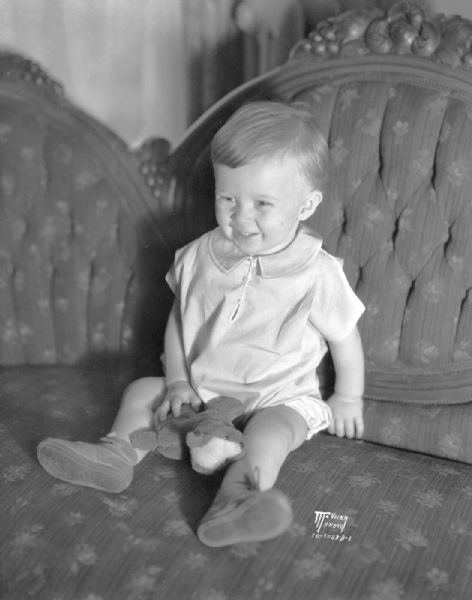 Hugh Fraser McGruer sitting on a sofa (on first birthday). He was born on Thanksgiving Day, 1930.